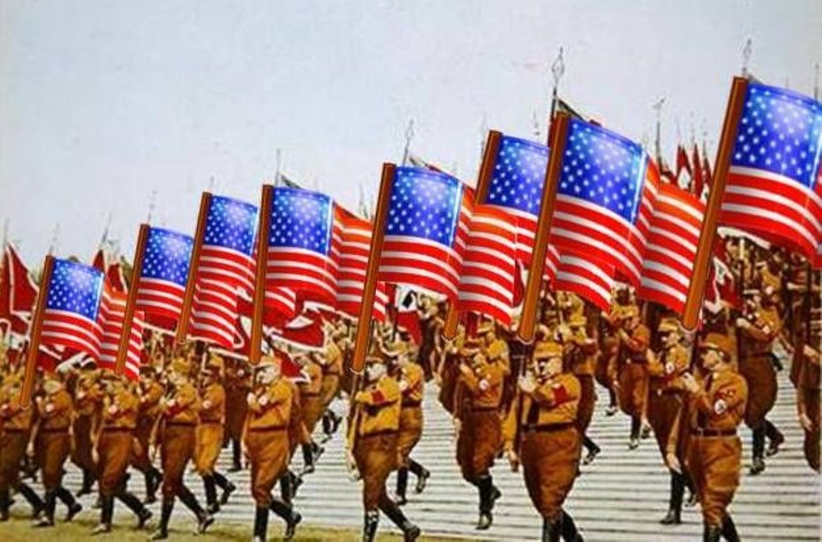 Men marching on steps carrying American flags