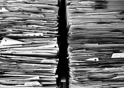 piles of files and paperwork in black and white